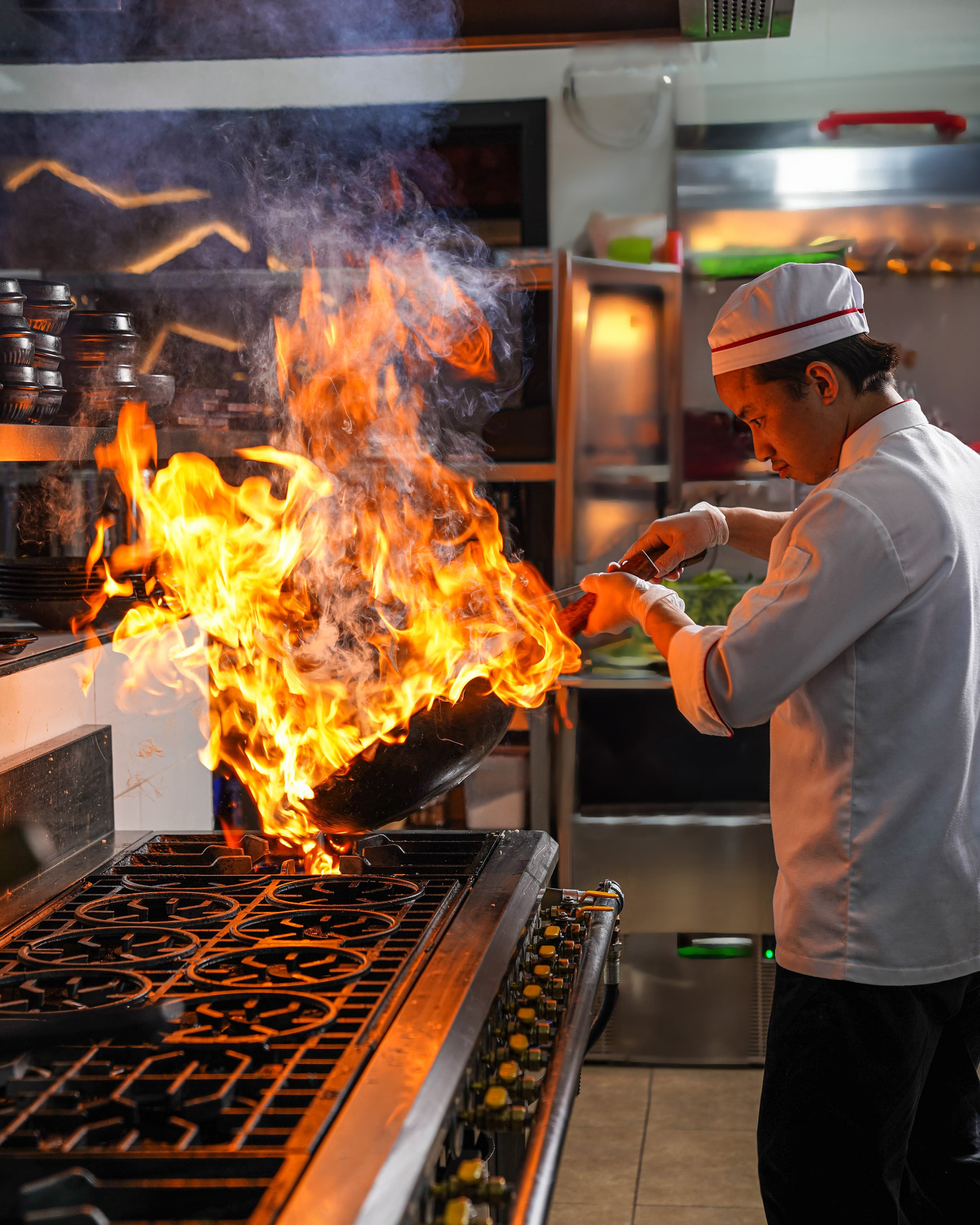 A Yee Hwa chef cooking at the grill